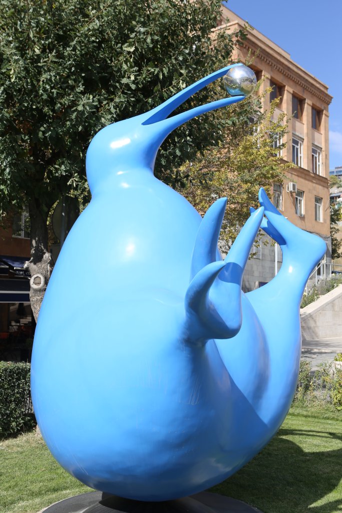 A giant whimsical sculpture of a blue kiwi balancing on its butt by Peter Wojtuk at the Cascade outdoor sculpture park.