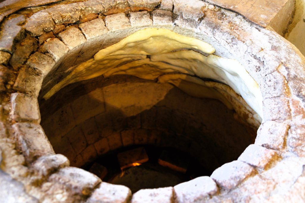 Lavash bread, baking in a traditional, clay, tandoor oven in Tbilisi.