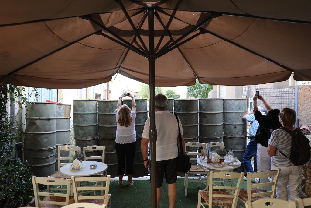 Tourists, at a cafe which sits against the southern side of the UN Buffer Zone, taking photos across the Green Line.