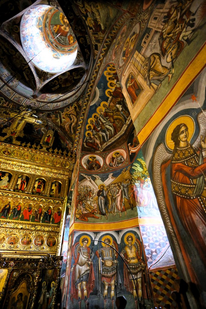The interior of the church at Moldovița Monastery is covered in colourfyul frescoes which depict the crucifixion of Jesus.