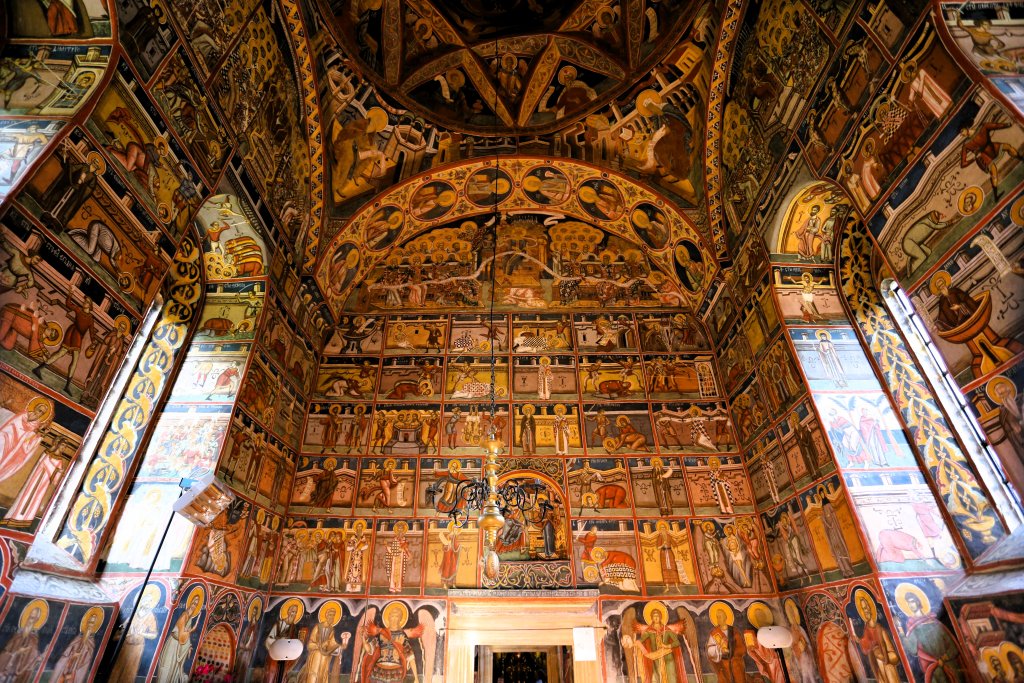 The interior of the church at Moldovița Monastery is covered in the most elaborate and colourful frescoes, which depict the crucifixion of Jesus.