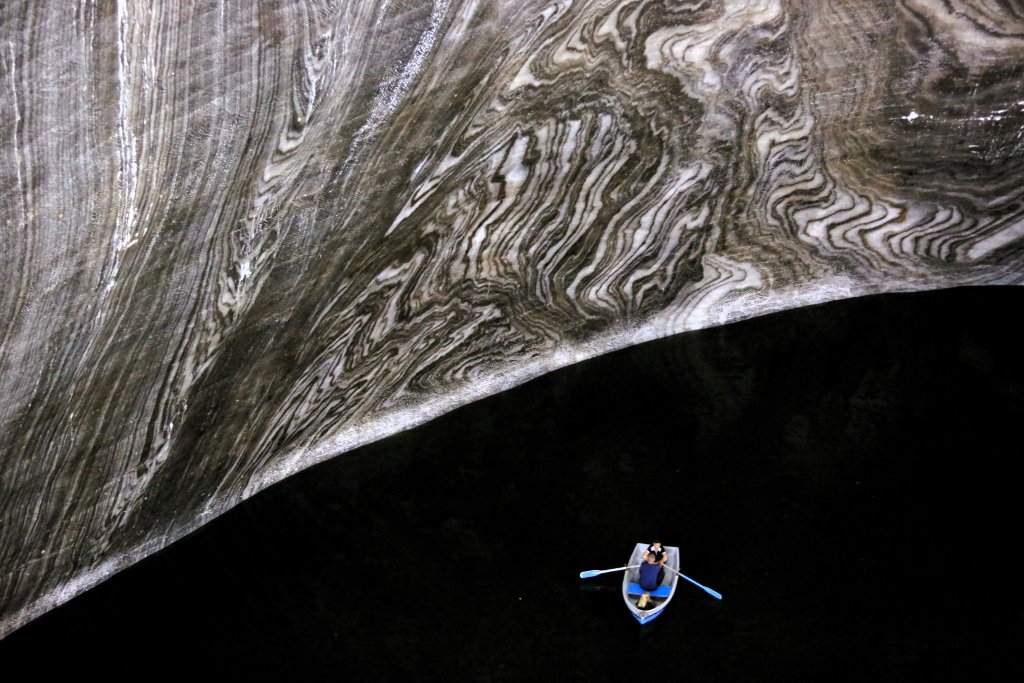 Enclosed within a 90-metre (295 ft) deep, bell-shaped, chamber which has been carved out from the smooth salt-stone, the underground lake at the bottom of the Terezia Mine at Turda Salina has a maximum depth of around 8 metres (26 feet).