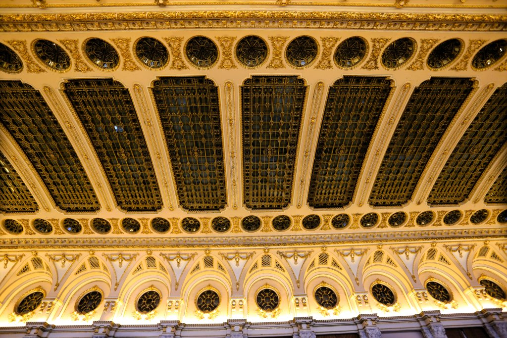 A view of one of the many highly decorated ceilings in the Palace of Parliament building in Bucharest.