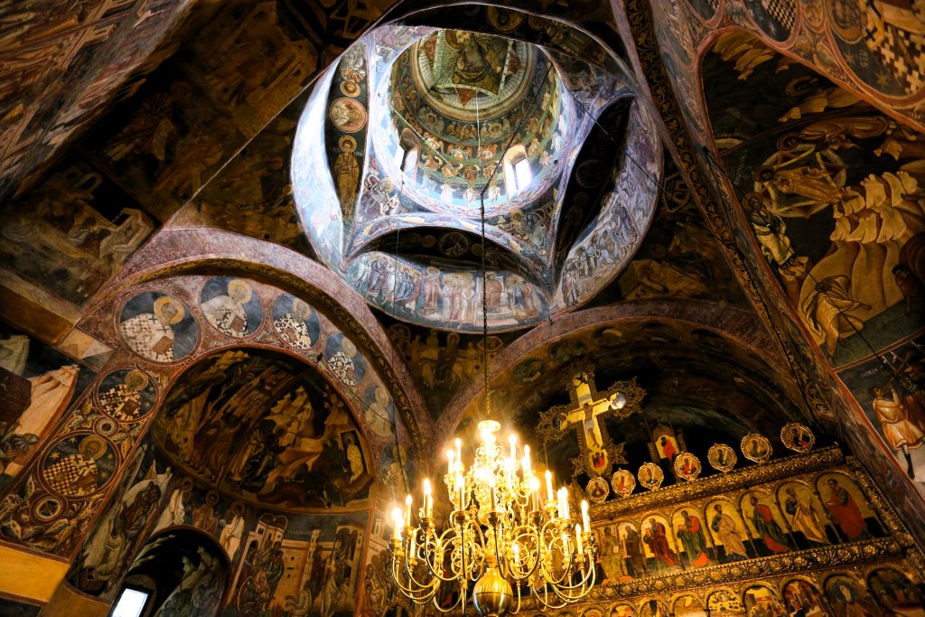 A view of the richly decorated interior of the church at Voronet Monastery.
