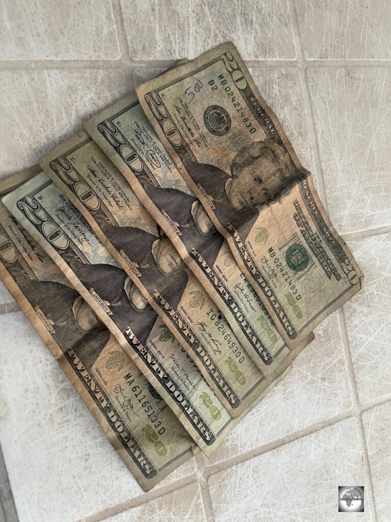 While the US dollar circulates widely alongside the Liberian dollar, the condition of USD banknotes is always bad, such as these shabby notes which were issued by a local ATM.