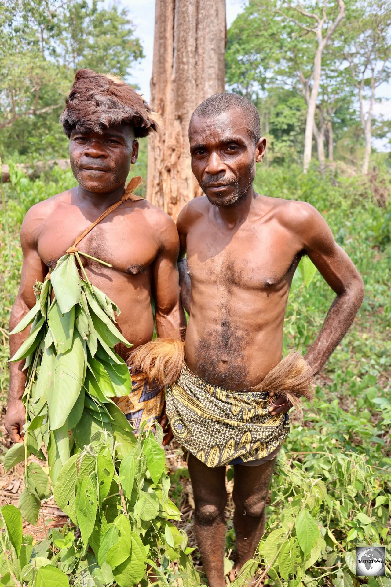 The chief of the Aka Pygmy village (left), wearing his traditional head-dress.