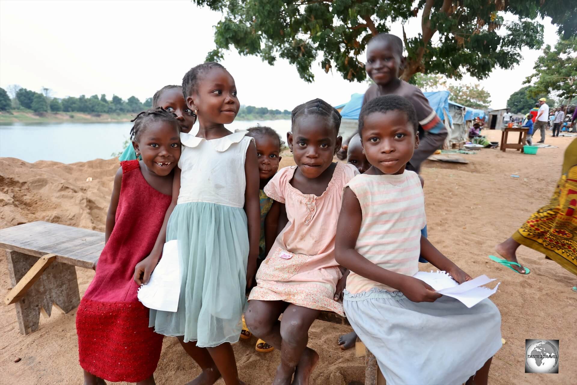 Children at "Camp île Bongo Soua", a refugee camp which houses those who lost their homes on nearby Bongo Soua Island (background) due to flooding.
