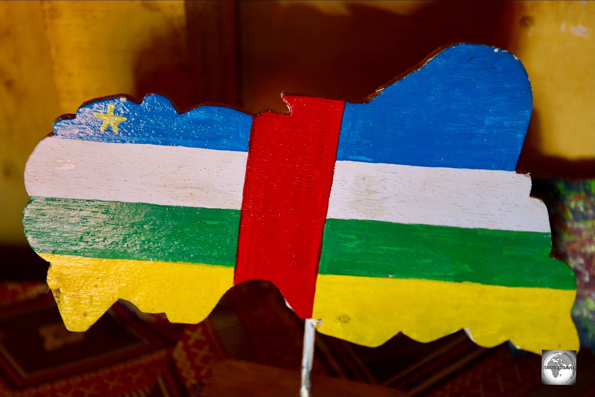 A wooden map of the Central African Republic, painted with the colours of the national flag.