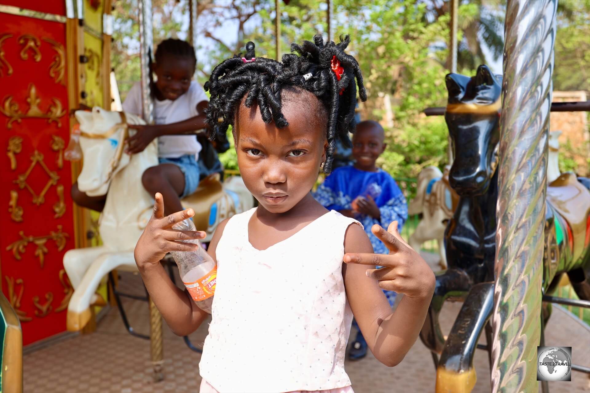 Children play on a carousel in the garden of the Maison Russe in Bangui.