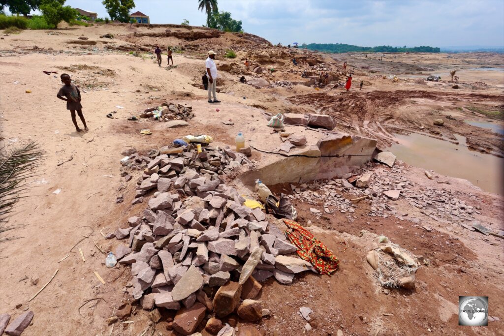 The pink sandstone quarry spans a huge area with hundreds of labourers working in small tenements.