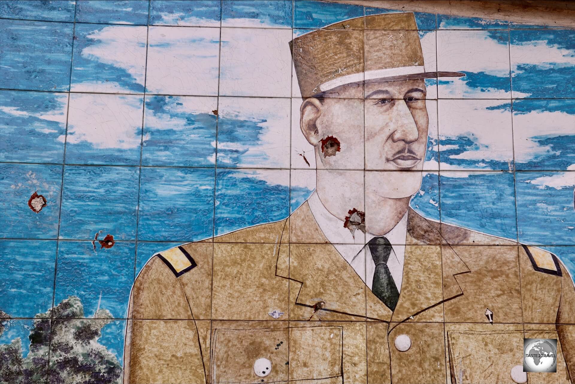 Unfortunately, the (mosaic) face of de Gaulle has been shot twice by bullets!