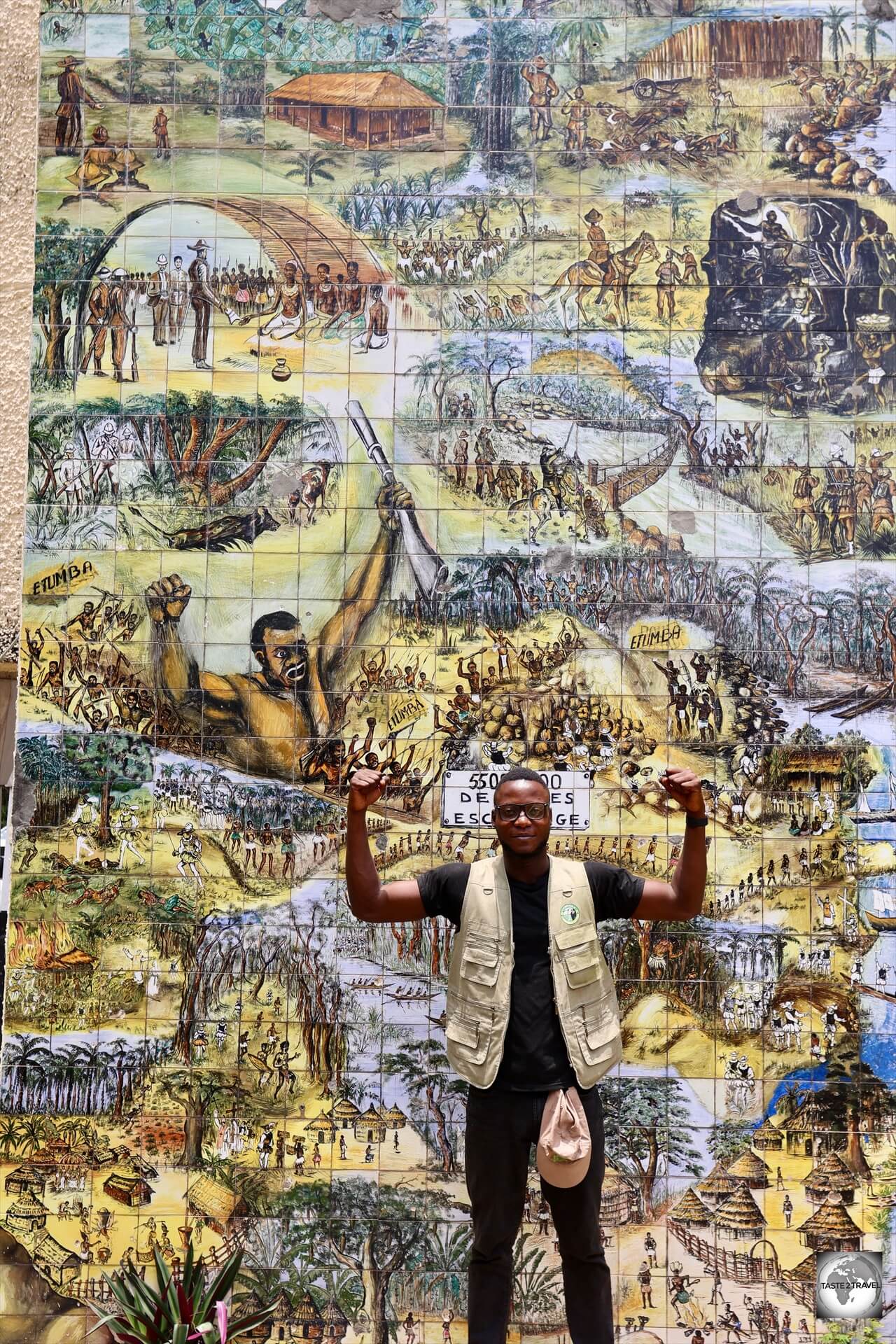My guide, Satch, being strong, alongside the strong warrior, on the Fresque de l'Afrique in Brazzaville.