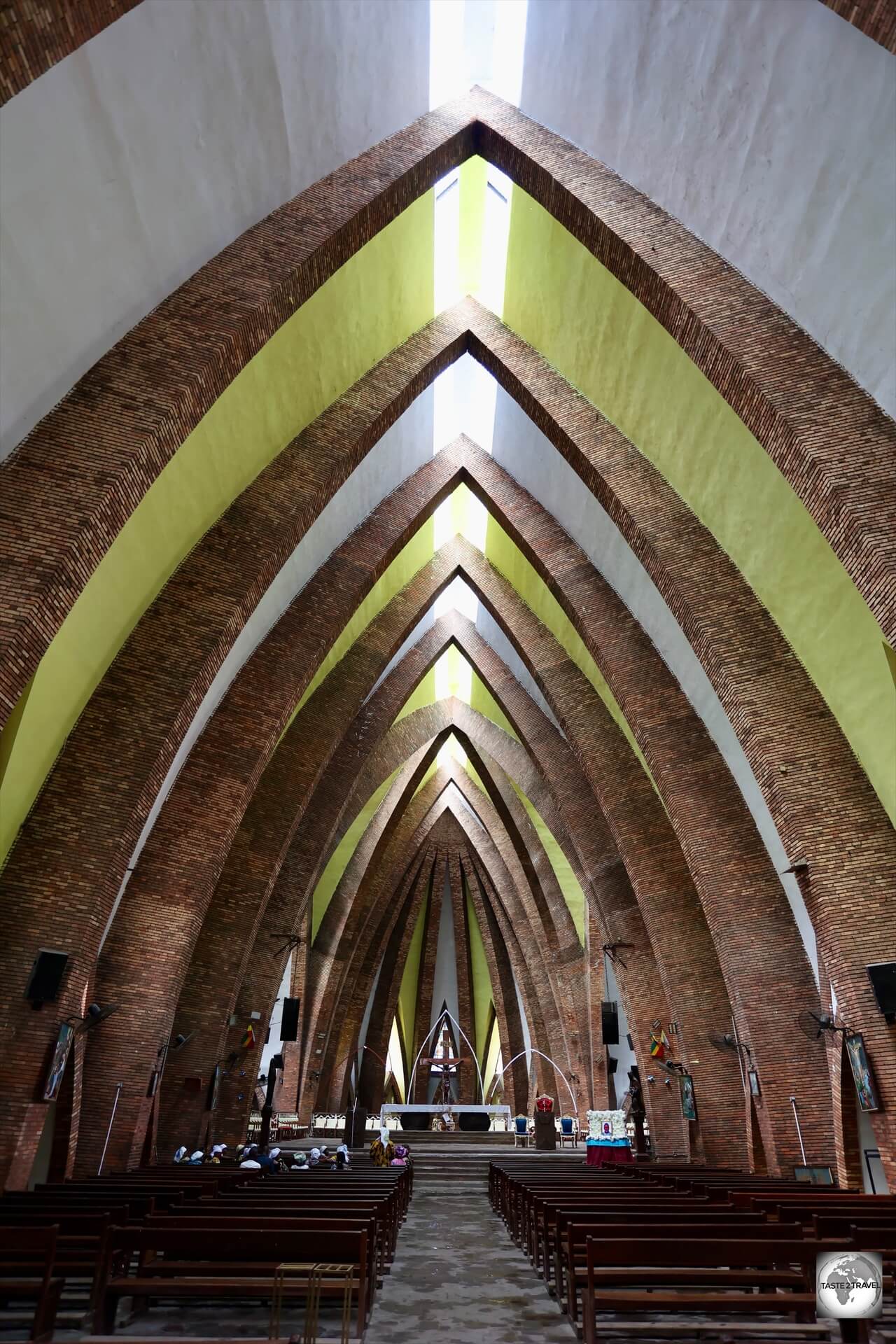 The interior of the basilica features pointy arches, inspired by Congolese spears.