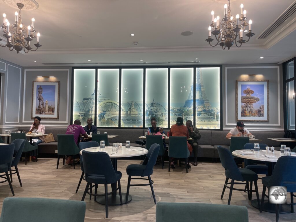 The dining room at Paul in Brazzaville, with its images of a very distant Paris, which is the dream destination for most Congolese.