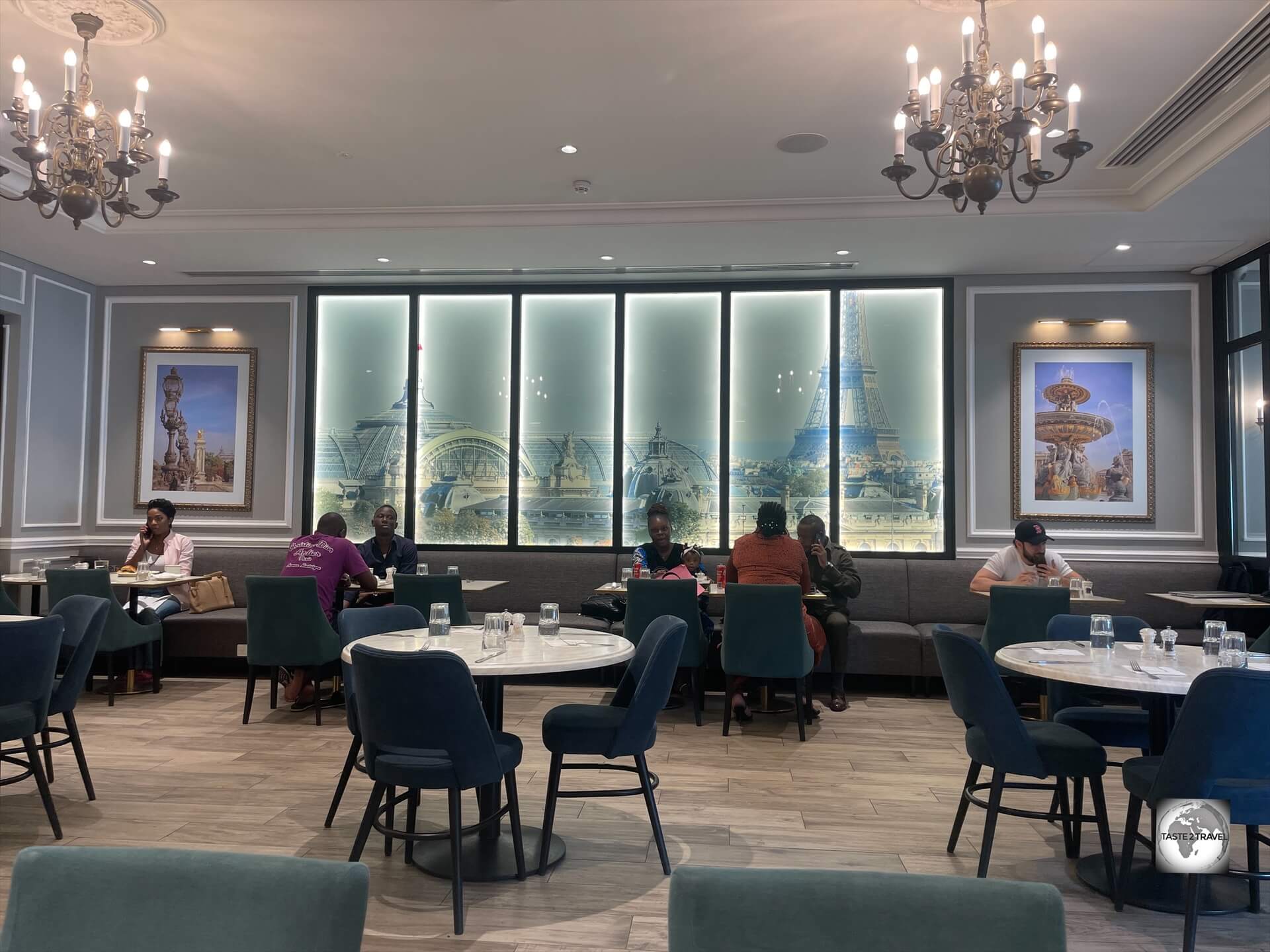The dining room at Paul in Brazzaville, with its images of a very distant Paris, which is the dream destination for most Congolese.