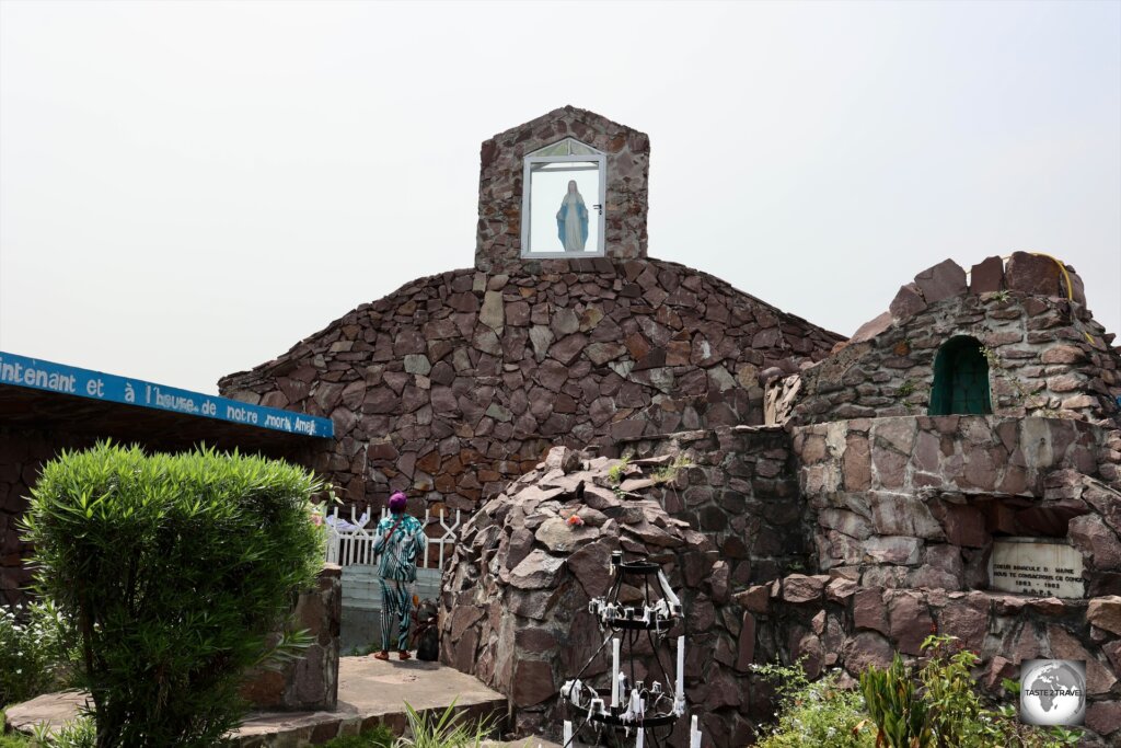 A grotto, next to Sainte-Anne of the Congo Basilica, is a popular spot for praying locals.