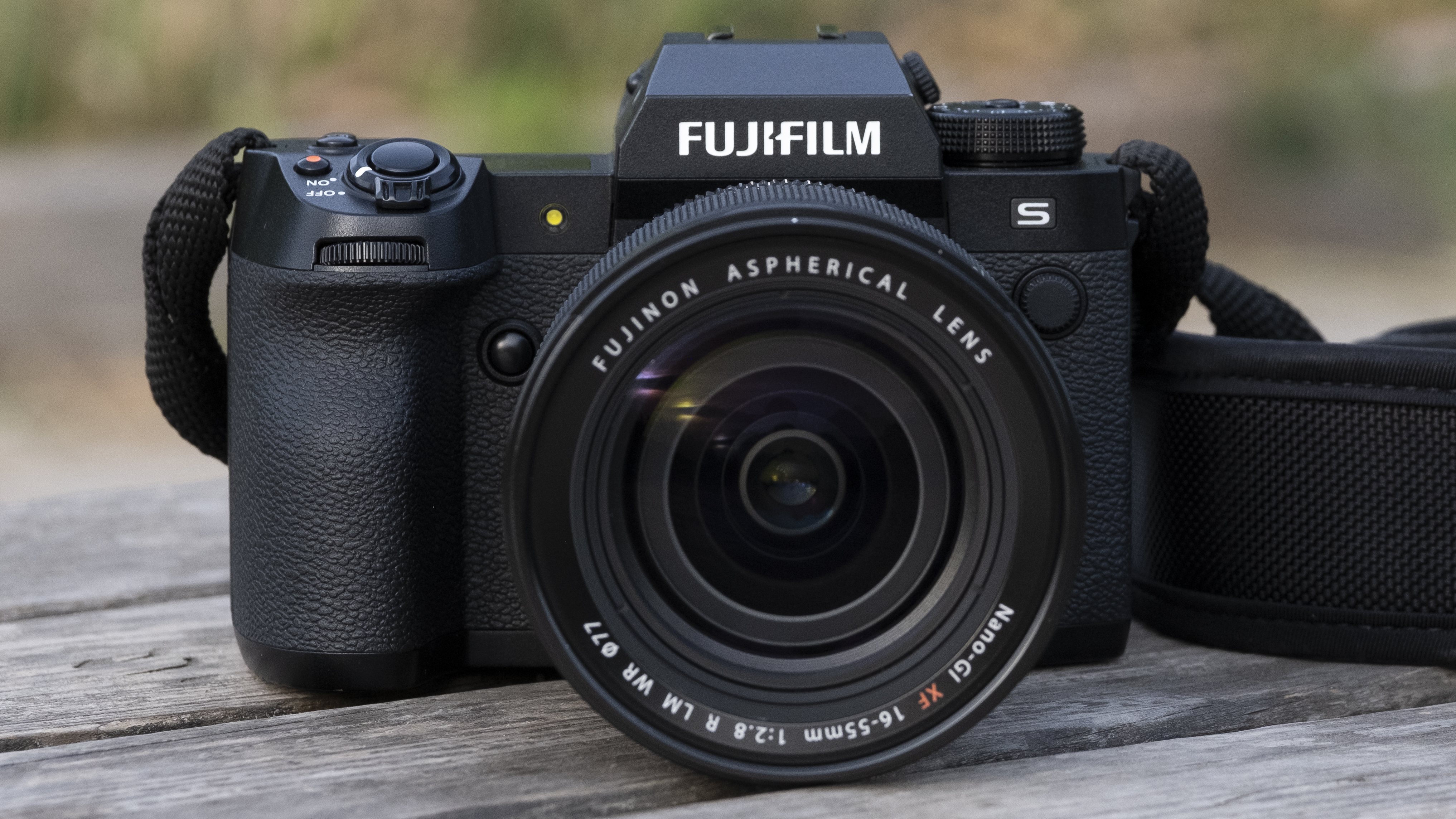 The Fujifilm X-H2S camera sitting on a wooden bench