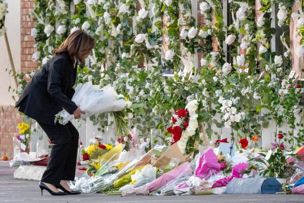 Vice President Kamala Harris places flowers on a memorial at...