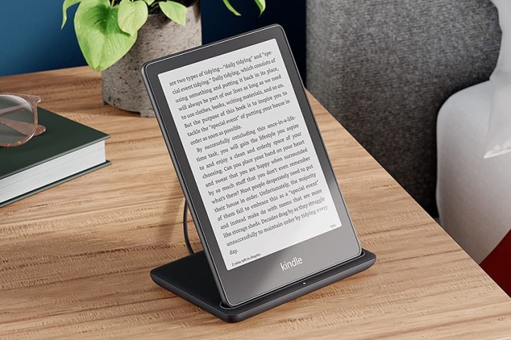 Kindle Paperwhite Signature Edition propped up for reading on a table.