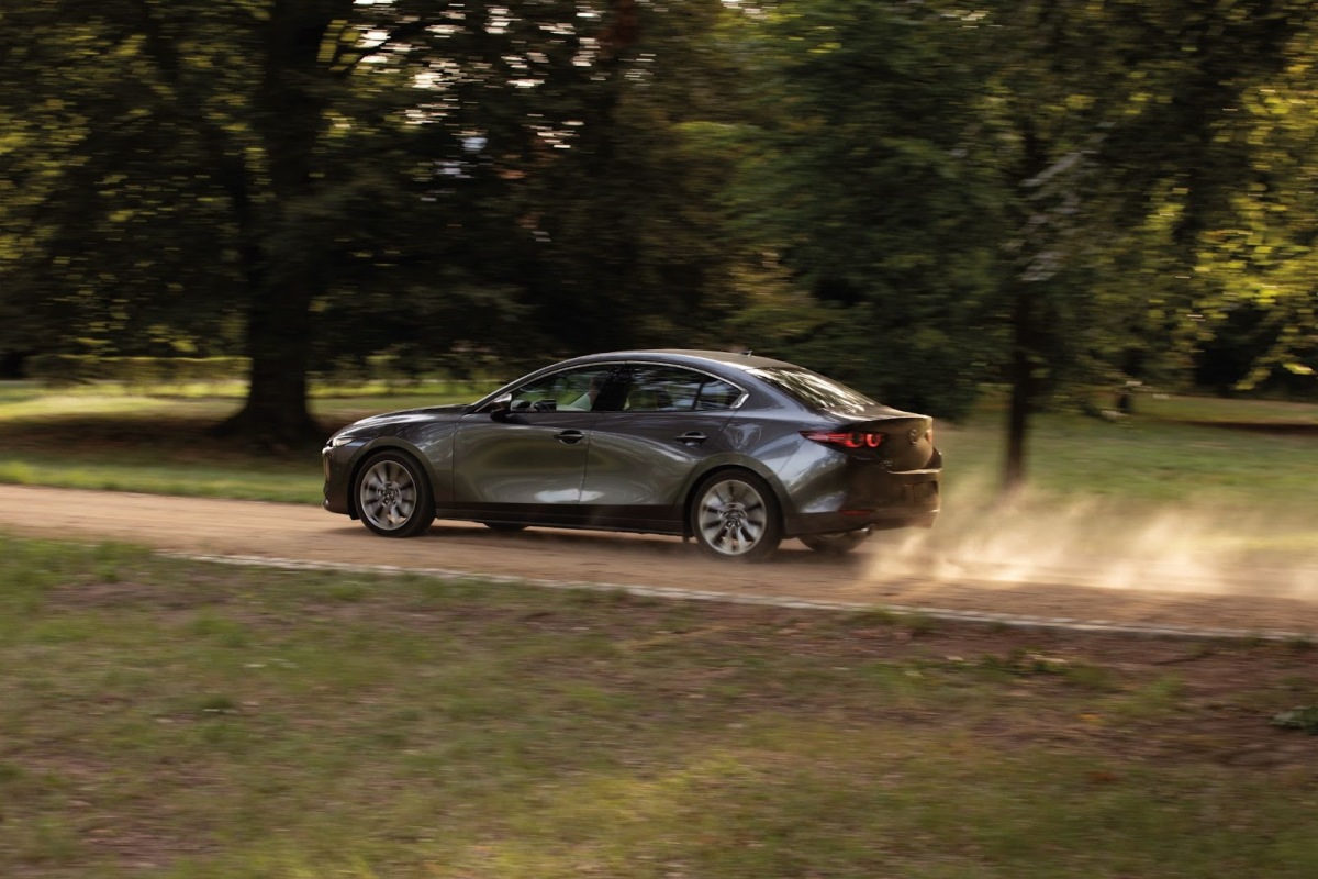 A new Mazda3 sedan on a dirt road