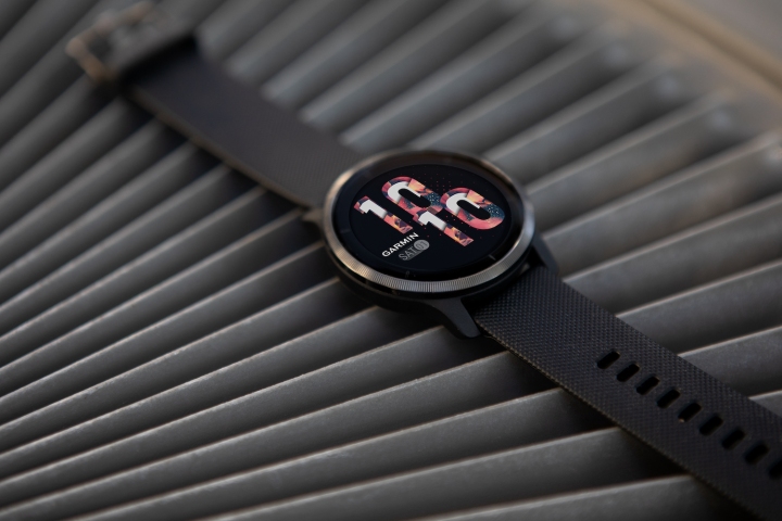 The Garmin Venu 2s smartwatch, placed on a ridged surface.