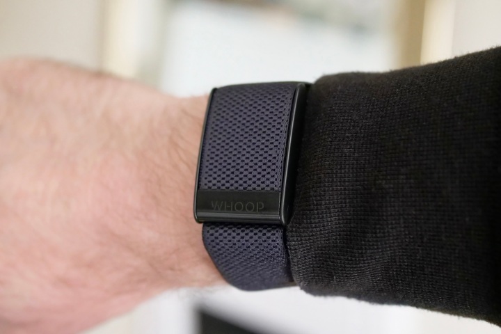 The front of the Whoop 4.0 on a person's wrist.