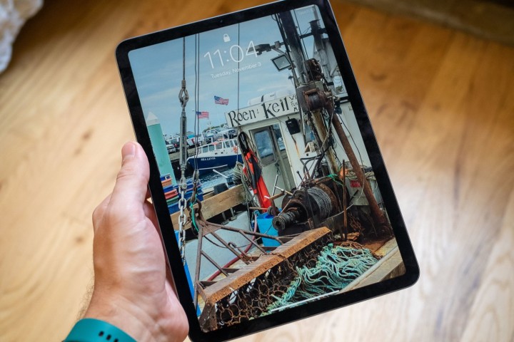 A man holding the Apple iPad Air fifth generation.