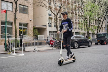 riding Unagi Model One Voyager electric scooter 