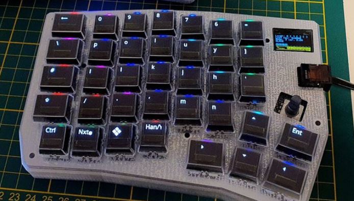 The PolyKybd, a mechanical split keyboard with OLED screens in the keys.