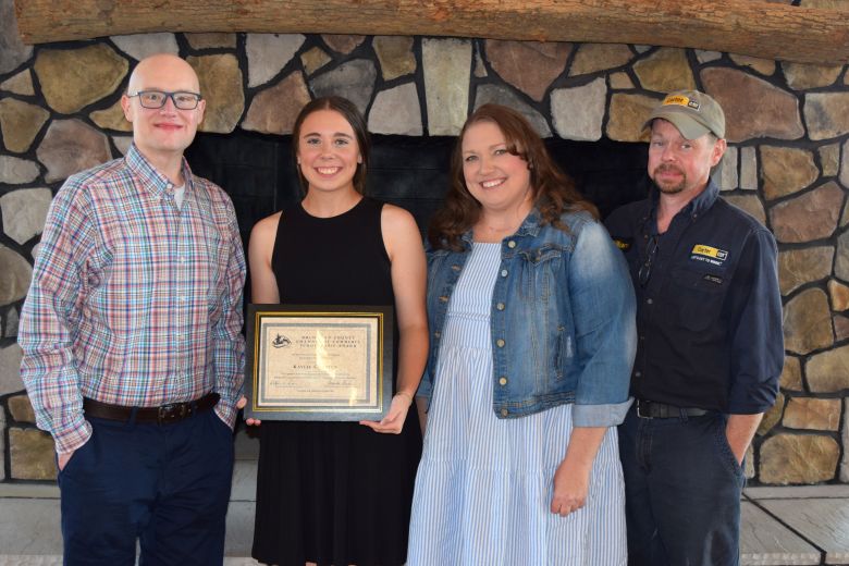 Kaylee Compton, second from left, was the winner of a $1,500 Buchanan County Chamber of Commerce Scholarship. She is pictured here with Chamber Board of Directors member Ryan Clevinger, who made the presentation and her parents, Deana and William Compton. 
