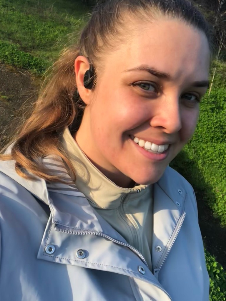 Emma Rossiter, a young woman with dark hair, poses with waterproof headphones in her ear