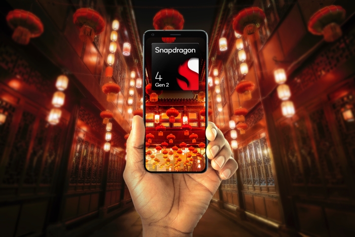 Hand holding phone with Qualcomm Snapdragon 4 Gen 2 logo.