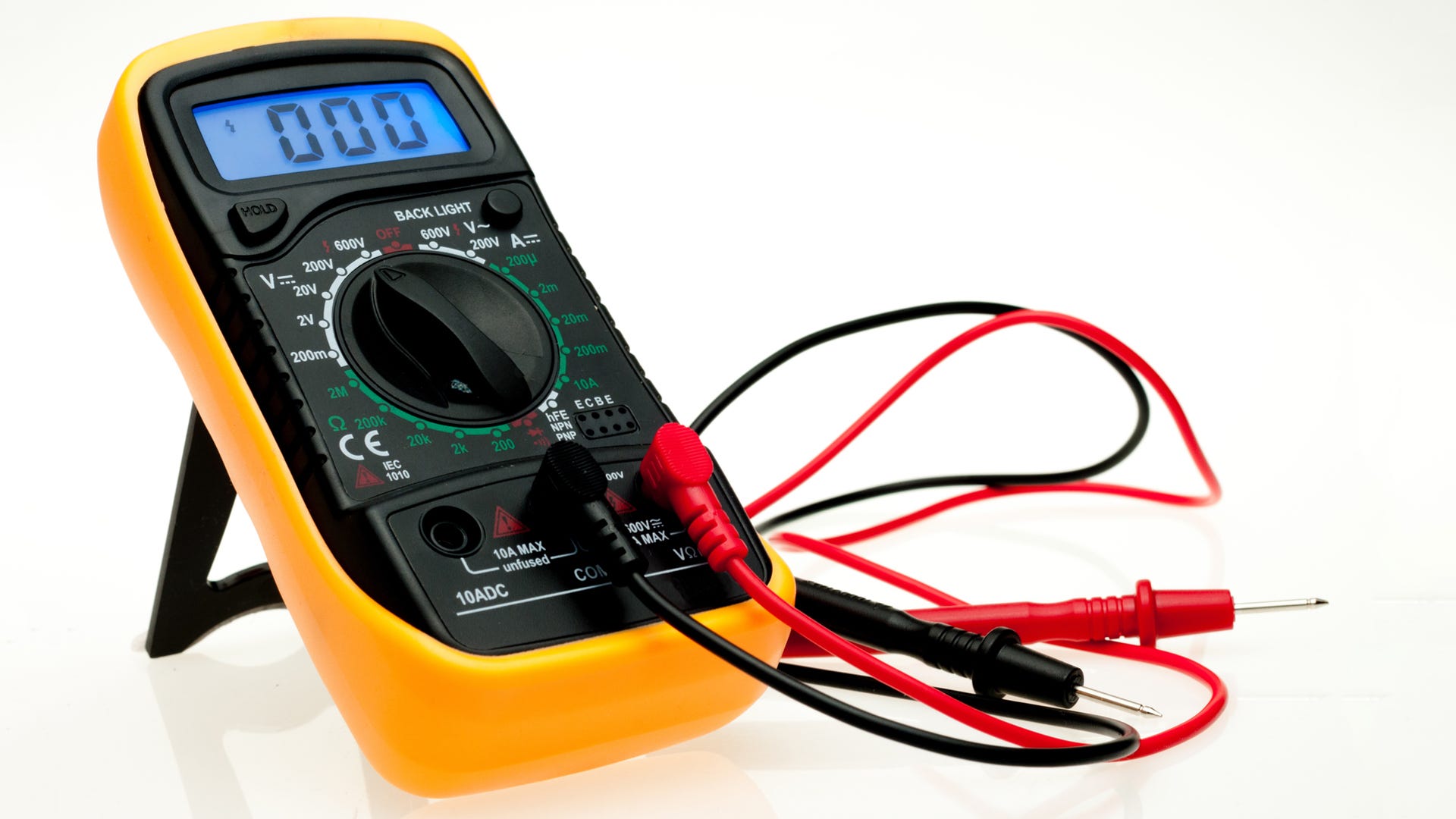 Digital multimeter with probes and blue backlit display on a white background.