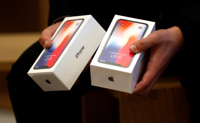 FILE PHOTO: A man holds two boxes for the Apple???s new iPhone X which went on sale today, at the Apple Store in Regents Street in London, Britain, November 3, 2017. REUTERS/Peter Nicholls/File Photo