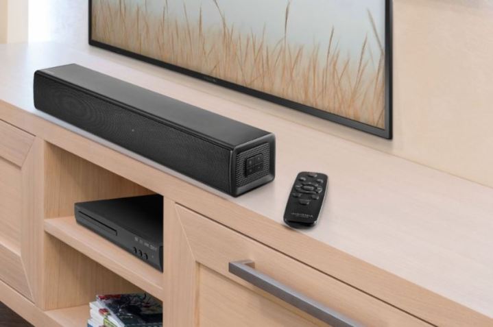 An Insignia Mini soundbar sitting under a TV.