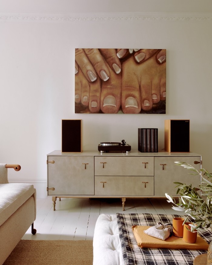 A painting by Issy Wood above the BDDW leather credenza in the living room