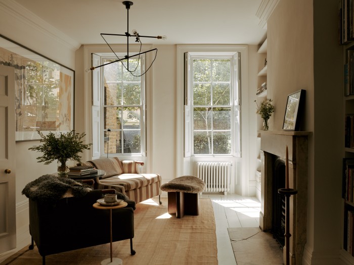Artwork by Jockum Nordström on the wall in the library, with BDDW chairs, stool by Alistair Byars and an early-20th-century kilim rug