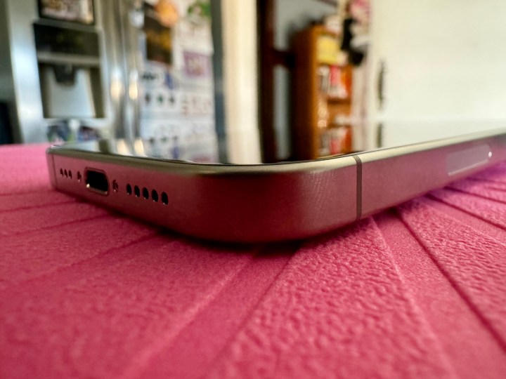 Natural Titanium iPhone 15 Pro showing curved edges in a closeup shot.