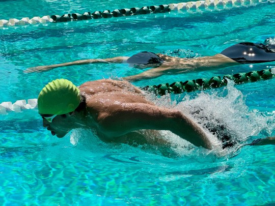Two swimmers racing in a pool.