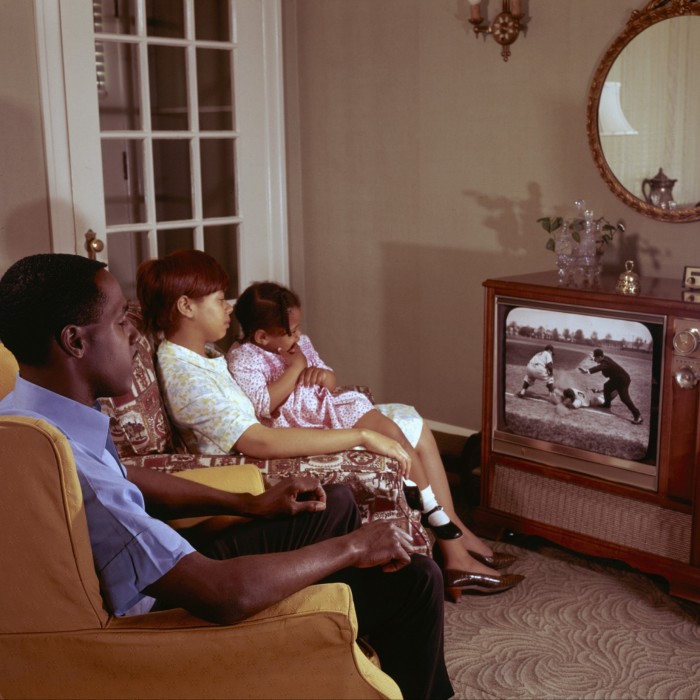 A family watches television together at home