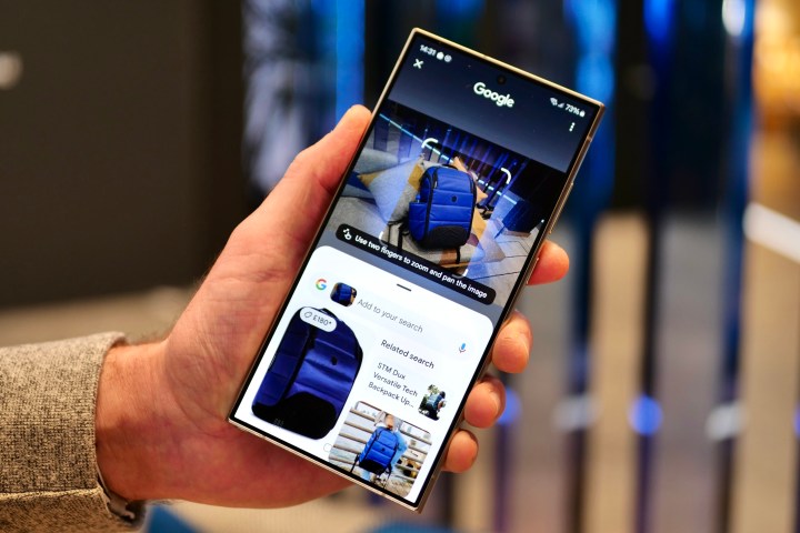 A person holding the Samsung Galaxy S24 Ultra using the Circle to Search feature.