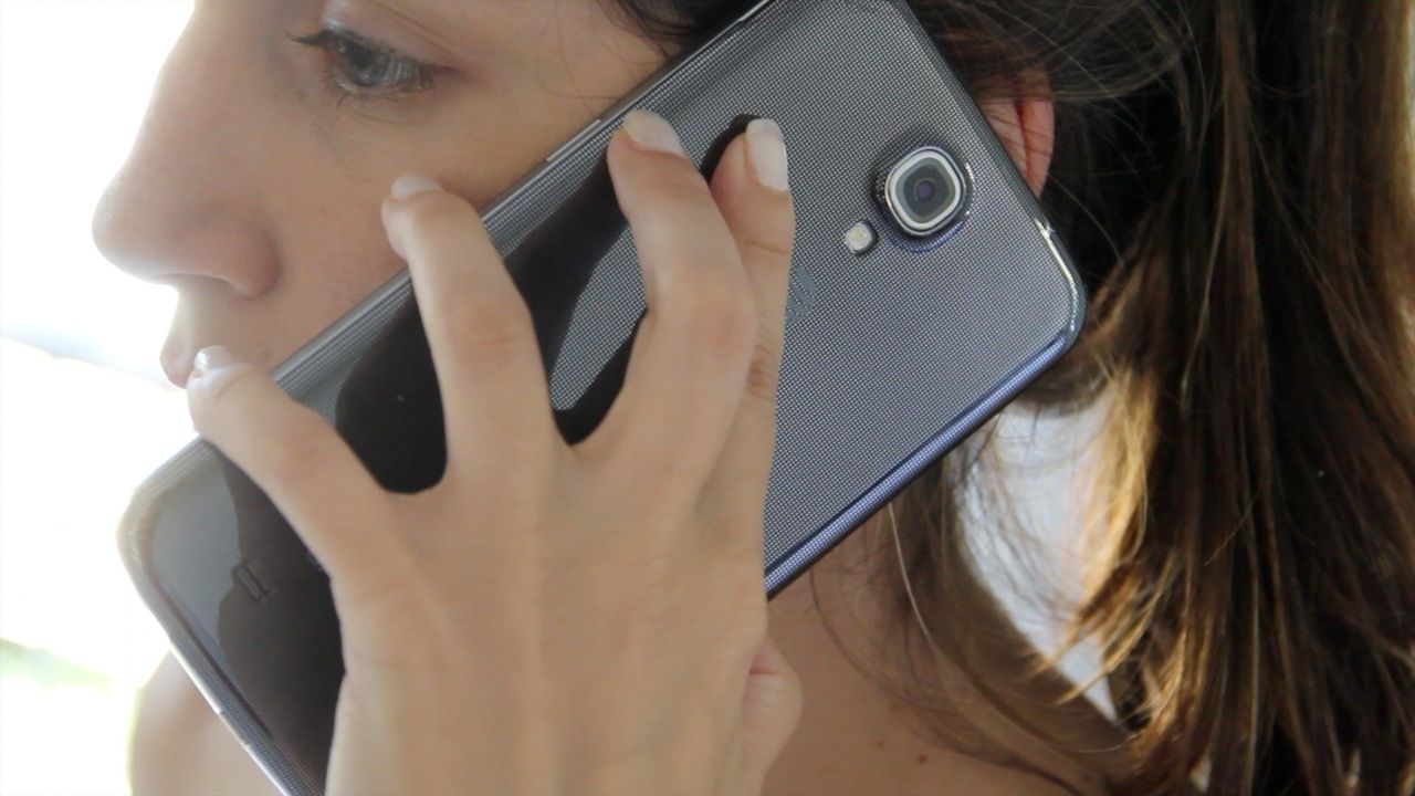 A woman holding the Samsung Galaxy Mega to her ear