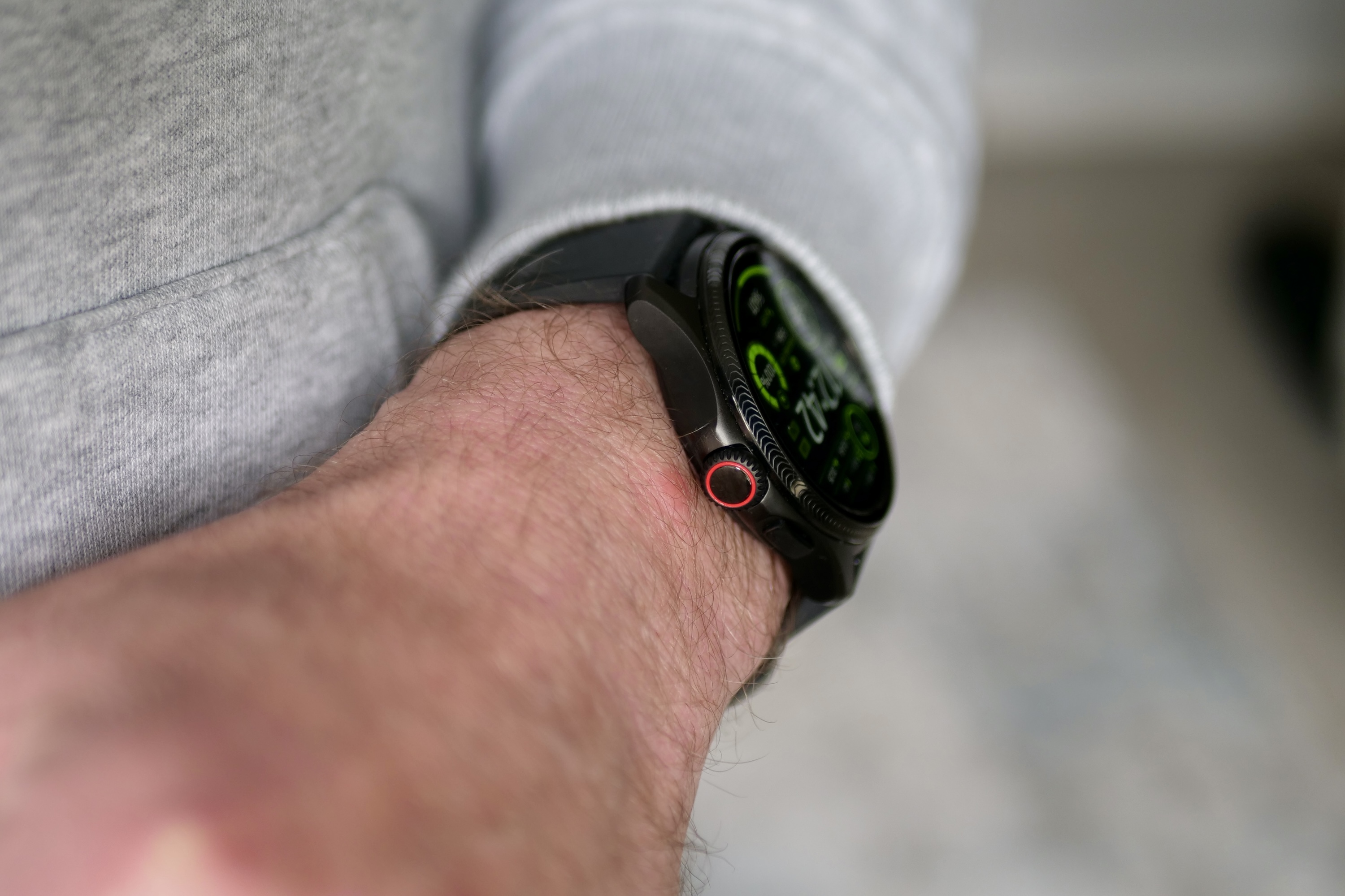 A person wearing the Mobvoi TicWatch Pro 5 Enduro, showing the crown.