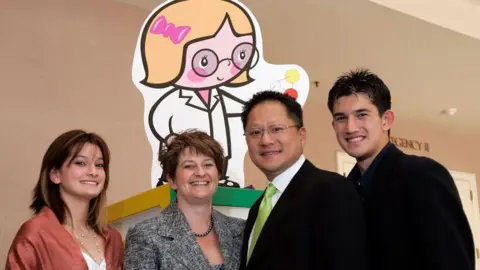 Getty Images Jensen Huang with his family (L-R) - daughter Madison, wife Lori and son Spencer.