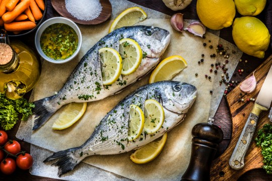 Cooking fish meat with lemon, parsley and garlic