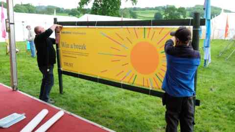 Signs that include Baillie Gifford are removed in Hay-on-Wye, Wales