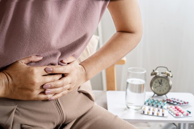 woman hand holding a stomachache 