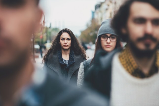 A picture of four people walking down the street