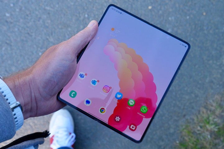 A person holding the open Galaxy Z Fold 4.