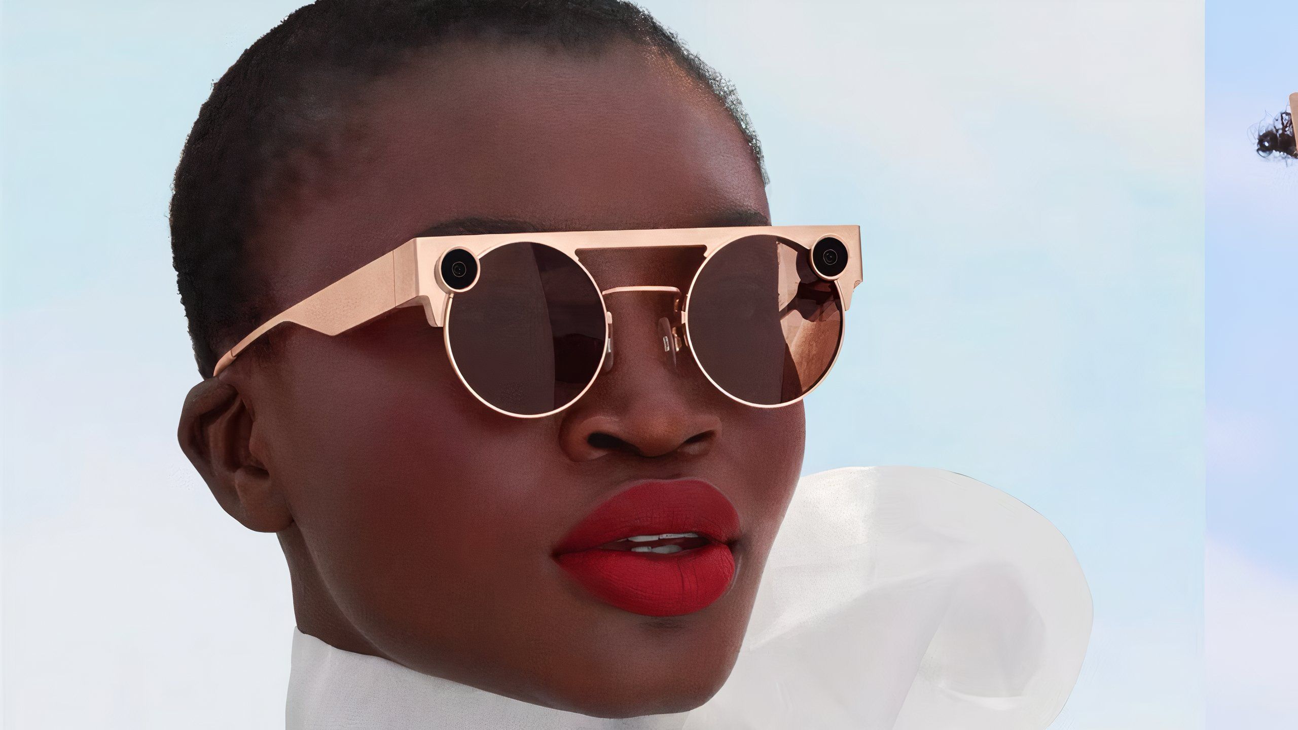 A model wearing gold snap Spectacles 3.